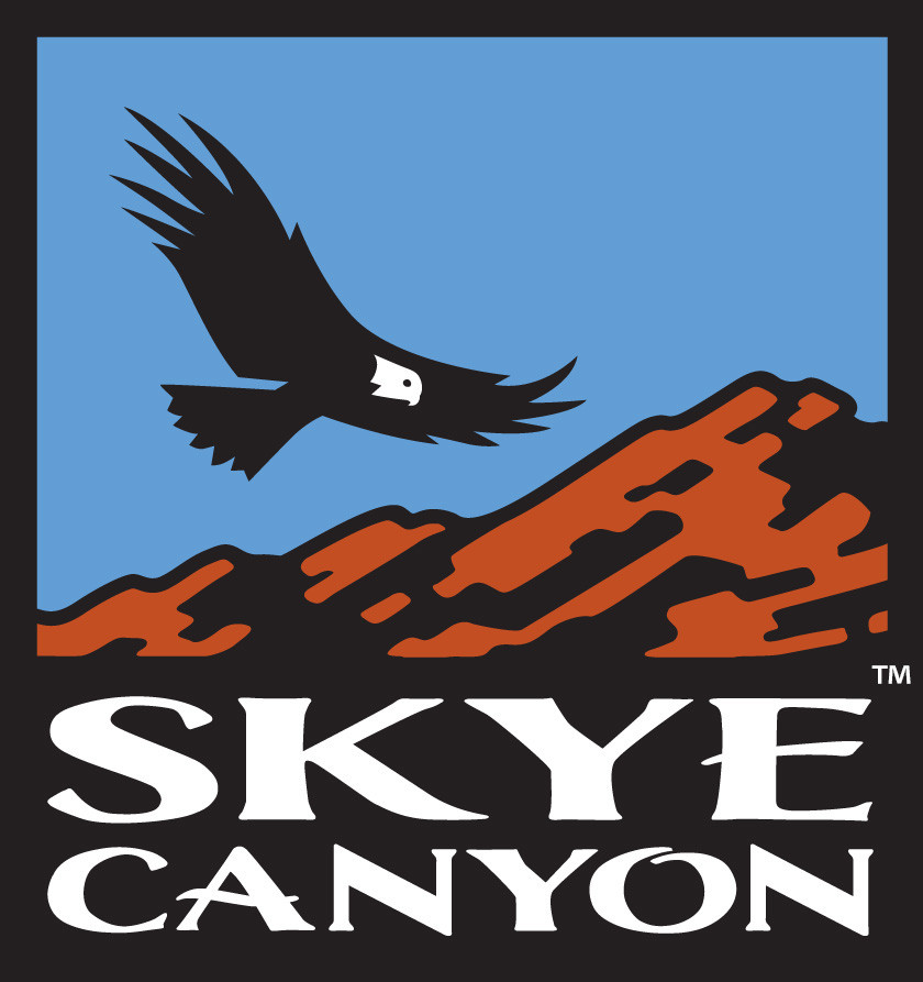 Eagle soaring over mountain landscape with blue sky, Skye Canyon logo, outdoor scenery.